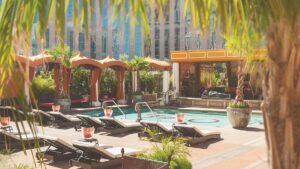 View of the pool and lounge area on a sunny day with lots of chairs and cabanas at Tao Beach at the Venetian in Las Vegas, Nevada, USA